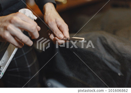 Barbershop. Close-up of barber holds razor for shaving his beard 101606862