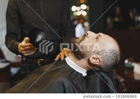 Man with a beard. Hairdresser with a client. Man with a brush. 101606868