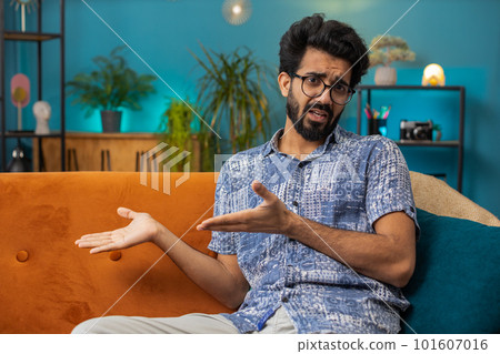 Indian man raising hands asking what why reason of failure disbelief irritation by troubles at home Indian man raising hands asking what why reason of failure disbelief irritation by troubles at home 101607016