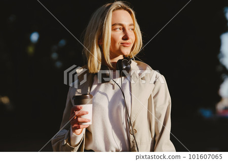 Portrait of beautiful blond. Model in summer city. Girl with cup of coffee. Portrait of beautiful blond. Model in summer city. Girl with cup of coffee. 101607065