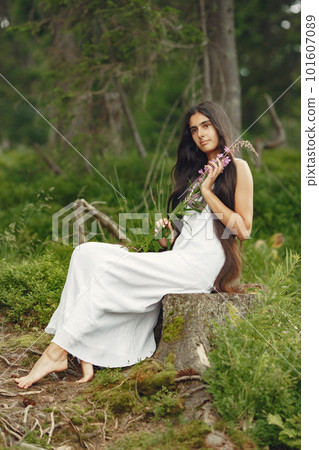 Indian woman with long hair. Lady in a blue dress. Girl with untouched nature. 101607089