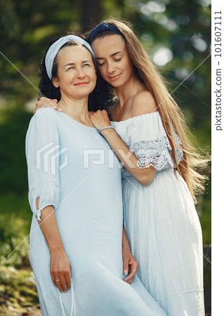 Women in a summer forest. Lady in a blue dress. Family posing and embracing. Women in a summer forest. Lady in a blue dress. Family posing and embracing. 101607111