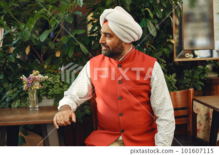 Indian man in a city. Male in a traditional turban. Hinduist in a summer city. 101607115