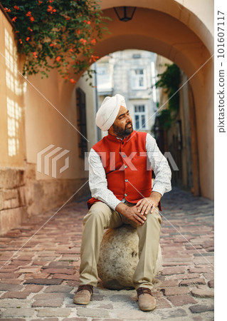 Indian man in a city. Male in a traditional turban. Hinduist in a summer city. Indian man in a city. Male in a traditional turban. Hinduist in a summer city. 101607117