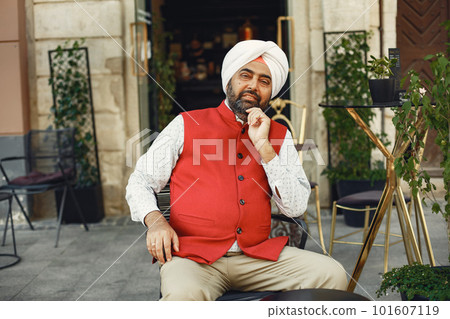 Indian man in a city. Male in a traditional turban. Hinduist in a summer city. Indian man in a city. Male in a traditional turban. Hinduist in a summer city. 101607119