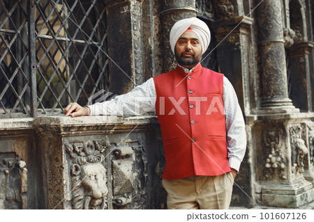 Indian man in a city. Male in a traditional turban. Hinduist in a summer city. 101607126