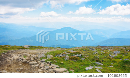 path through the green rolling hills. countryside mountain landscape in summer on a sunny day. mountain ridge in the distance. summer vacations in ukraine 101608635