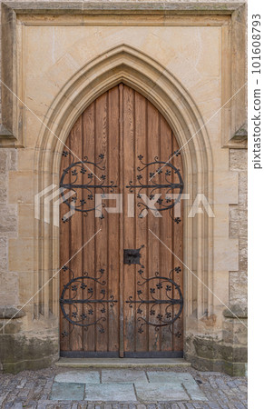 Old wooden door with large iron ornament Old wooden door with large iron ornament 101608793