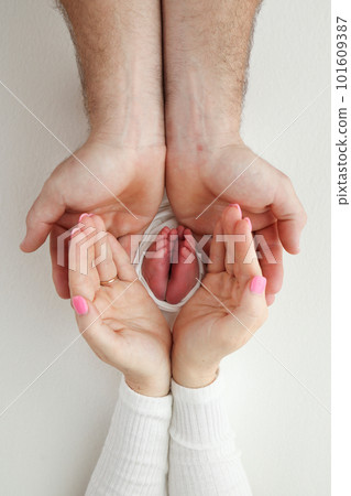 Feet, toes, heels of a newborn. Children's foot in the hands of mother, father, parents. Baby's legs in the arms of mom and dad. Mom and her child. Happy family concept. Macro photography, close-up. Feet, toes, heels of a newborn. Children's foot in the hands of mother, father, parents. Baby's legs in the arms of mom and dad. Mom and her child. Happy family concept. Macro photography, close-up. 101609387
