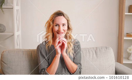 Evil plan. Ironic woman. Sarcastic expression. Smiling lady running fingers full of malicious joy sitting light room interior. Evil plan. Ironic woman. Sarcastic expression. Smiling lady running fingers full of malicious joy sitting light room interior. 101610128