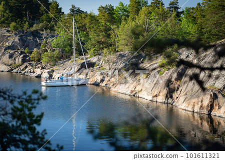 Sailboat anchored near remote rocky island in Stockholm archipelago. Adventure and travel concept Sailboat anchored near remote rocky island in Stockholm archipelago. Adventure and travel concept 101611321