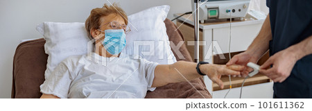 Nurse checking with fingertip pulse oximeter oxygen saturation of patient blood in hospital Nurse checking with fingertip pulse oximeter oxygen saturation of patient blood in hospital 101611362