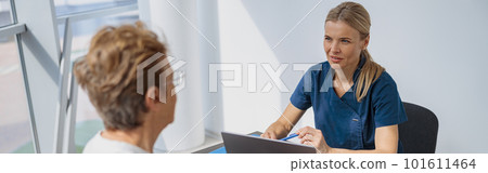 Smiling doctor fills out the medical report form on medical care of patients during appointment Smiling doctor fills out the medical report form on medical care of patients during appointment 101611464