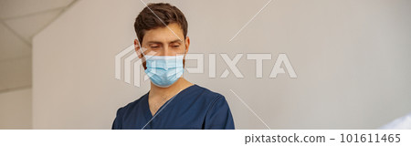 Doctor in mask writing medicine recomendation to patient in hospital ward during Covid-19 epidemic Doctor in mask writing medicine recomendation to patient in hospital ward during Covid-19 epidemic 101611465