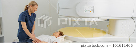 Radiologist controls MRI or CT or PET Scan with female patient undergoing procedure Radiologist controls MRI or CT or PET Scan with female patient undergoing procedure 101611466