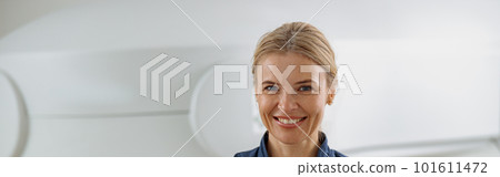 Radiologist showing thumbs up standing on background of MRI or CT Scan with patient on procedure Radiologist showing thumbs up standing on background of MRI or CT Scan with patient on procedure 101611472