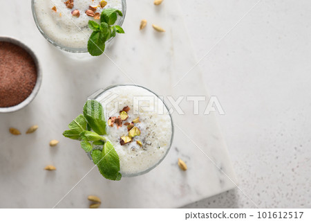 Indian Salty lassi with mint leaves and kala namak. Indian Salty lassi with mint leaves and kala namak. 101612517