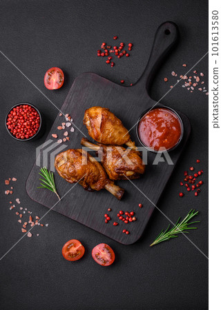 Delicious grilled chicken legs with spices and herbs in teriyaki sauce 101613580
