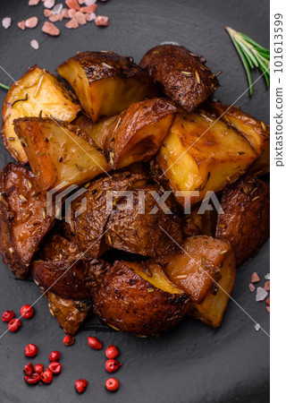 Delicious potatoes baked in their skins with rosemary and spices 101613599