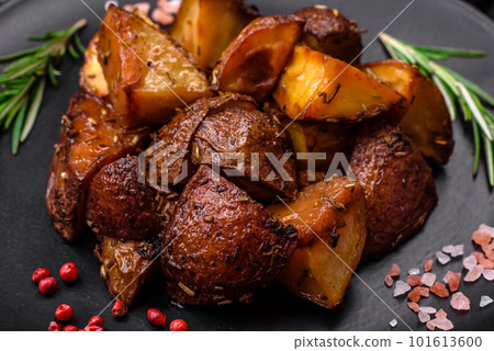 Delicious potatoes baked in their skins with rosemary and spices Delicious potatoes baked in their skins with rosemary and spices 101613600