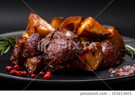 Delicious potatoes baked in their skins with rosemary and spices 101613601