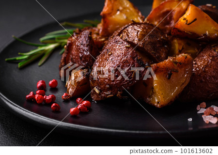Delicious potatoes baked in their skins with rosemary and spices Delicious potatoes baked in their skins with rosemary and spices 101613602