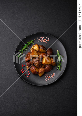 Delicious potatoes baked in their skins with rosemary and spices Delicious potatoes baked in their skins with rosemary and spices 101613607