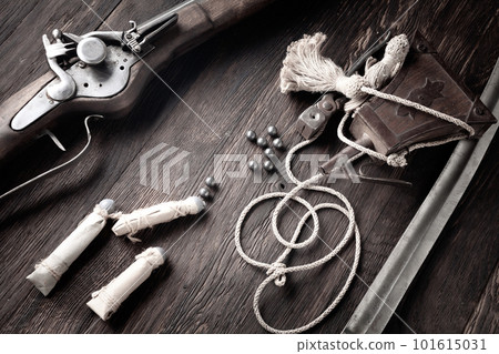 Ancient flintlock musket with powder flask and led bullets. 101615031