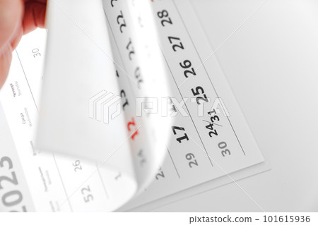 flipping through the pages of the flip calendar.  101615936