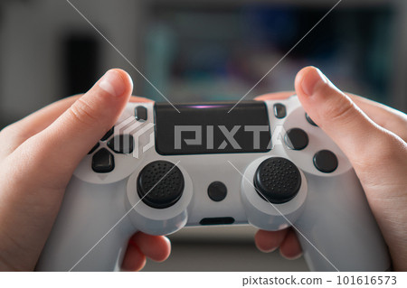Male hands hold modified plastic joystick closeup, selective focus. Person play videogames. Technologies and gaming. Male hands hold modified plastic joystick closeup, selective focus. Person play videogames. Technologies and gaming. 101616573