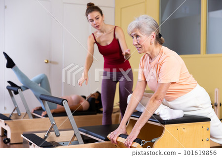 Mature woman trains on a combined chair 101619856