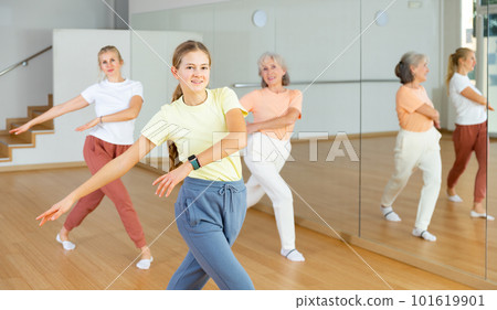 Girl dancing with her relatives during group training 101619901