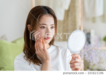 A young woman suffering from rough skin 101621196