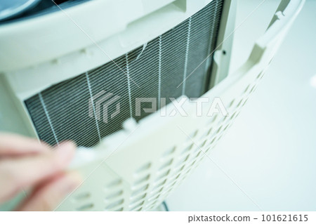 Dirty - dusty air purifier filter in living room. Air purifier machine lid or grille filter fully with a dust and polluted particle. Dirty - dusty air purifier filter in living room. Air purifier machine lid or grille filter fully with a dust and polluted particle. 101621615