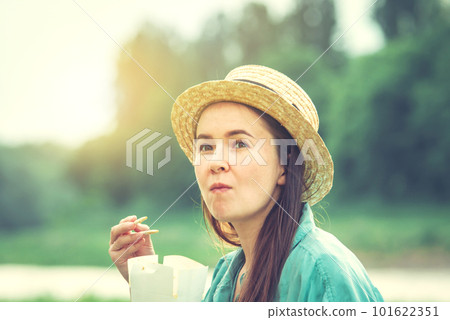 young caucasian woman eating thai food at sunset young caucasian woman eating thai food at sunset 101622351