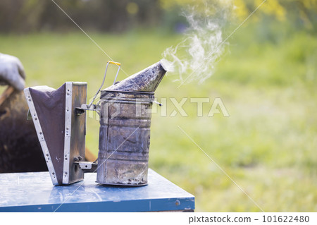 Beekeeping image Smoker placed on hive 101622480