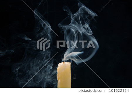 Smoke from an extinguished candle on a dark background. Smoke from an extinguished candle on a dark background. 101622534