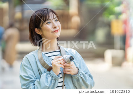 A woman traveling A woman taking pictures at a tourist spot A woman enjoying sightseeing A woman strolling at a tourist spot A woman traveling on a holiday 101622810