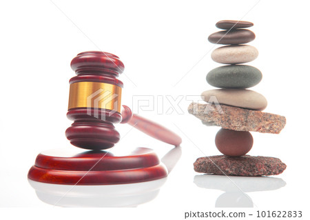 pyramid of stacked stones and a gavel of justice and law on a white background pyramid of stacked stones and a gavel of justice and law on a white background 101622833