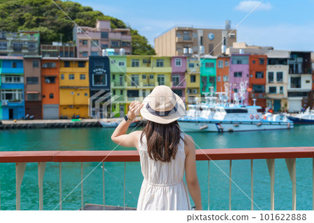 woman traveler visiting in Taiwan, Tourist with hat sightseeing in Keelung, Colorful Zhengbin Fishing Port, landmark and popular attractions near Taipei city . Asia Travel concept 101622888