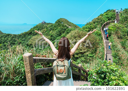 woman traveler visiting in Taiwan, Tourist with backpack sightseeing in Bitou Cape Hiking Trail, New Taipei City. landmark and popular attractions near Taipei. Asia Travel concept 101622891