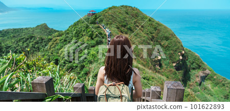 woman traveler visiting in Taiwan, Tourist with backpack sightseeing in Bitou Cape Hiking Trail, New Taipei City. landmark and popular attractions near Taipei. Asia Travel concept 101622893