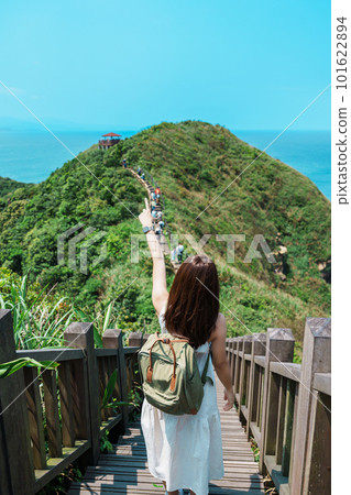 woman traveler visiting in Taiwan, Tourist with backpack sightseeing in Bitou Cape Hiking Trail, New Taipei City. landmark and popular attractions near Taipei. Asia Travel concept 101622894