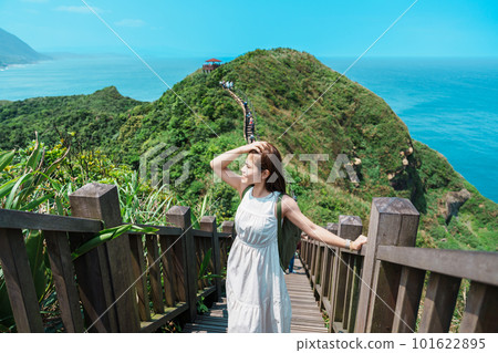 woman traveler visiting in Taiwan, Tourist with backpack sightseeing in Bitou Cape Hiking Trail, New Taipei City. landmark and popular attractions near Taipei. Asia Travel concept 101622895