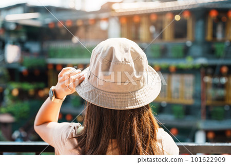 woman traveler visiting in Taiwan, Tourist with hat and backpack sightseeing in Jiufen Old Street village with Tea House background. landmark and popular attractions near Taipei city. Travel concept woman traveler visiting in Taiwan, Tourist with hat and backpack sightseeing in Jiufen Old Street village with Tea House background. landmark and popular attractions near Taipei city. Travel concept 101622909
