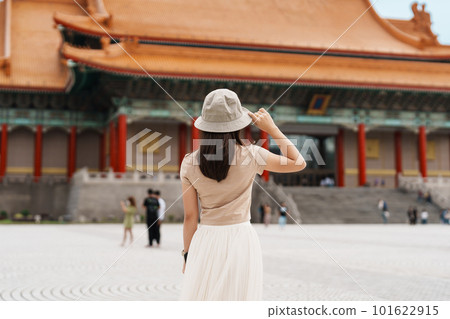 woman traveler visiting in Taiwan, Tourist with hat sightseeing in National Chiang Kai shek Memorial or Hall Freedom Square, Taipei City. landmark and popular attractions. Asia Travel concept 101622915