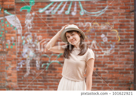 woman traveler visiting in Taiwan, Tourist with backpack and hat sightseeing in Bopiliao Historic Block, landmark and popular attractions in Taipei city. Asia Travel woman traveler visiting in Taiwan, Tourist with backpack and hat sightseeing in Bopiliao Historic Block, landmark and popular attractions in Taipei city. Asia Travel 101622921