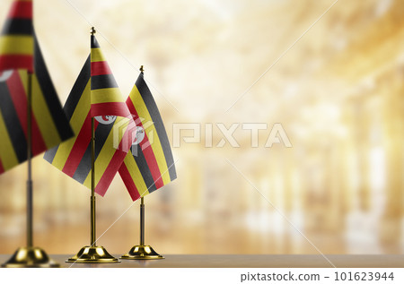 Small flags of the Uganda on an abstract blurry background Small flags of the Uganda on an abstract blurry background 101623944