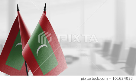Small flags of the Maldives on an abstract blurry background 101624053