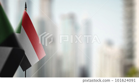 Small flags of the Sudan on an abstract blurry background 101624091